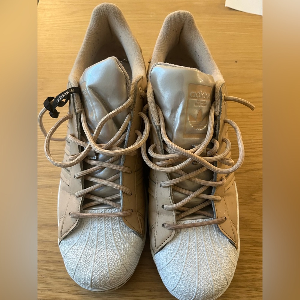Tan and silver adidas superstar sneakers